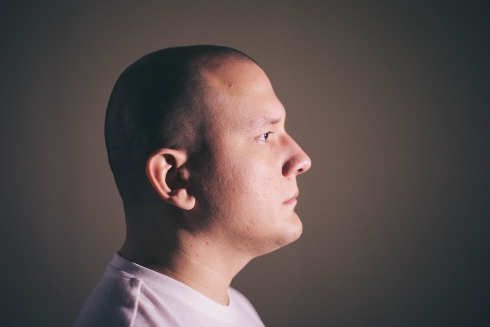 A clean profile: side-on, neutral expression, plain studio background
